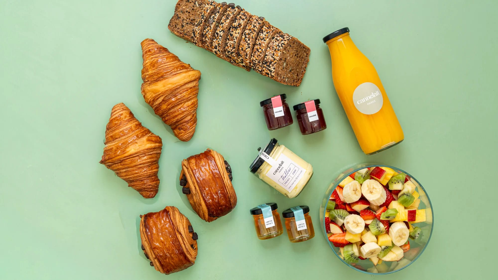 petit mini breakfast with croissants, jams, bread and orange juice