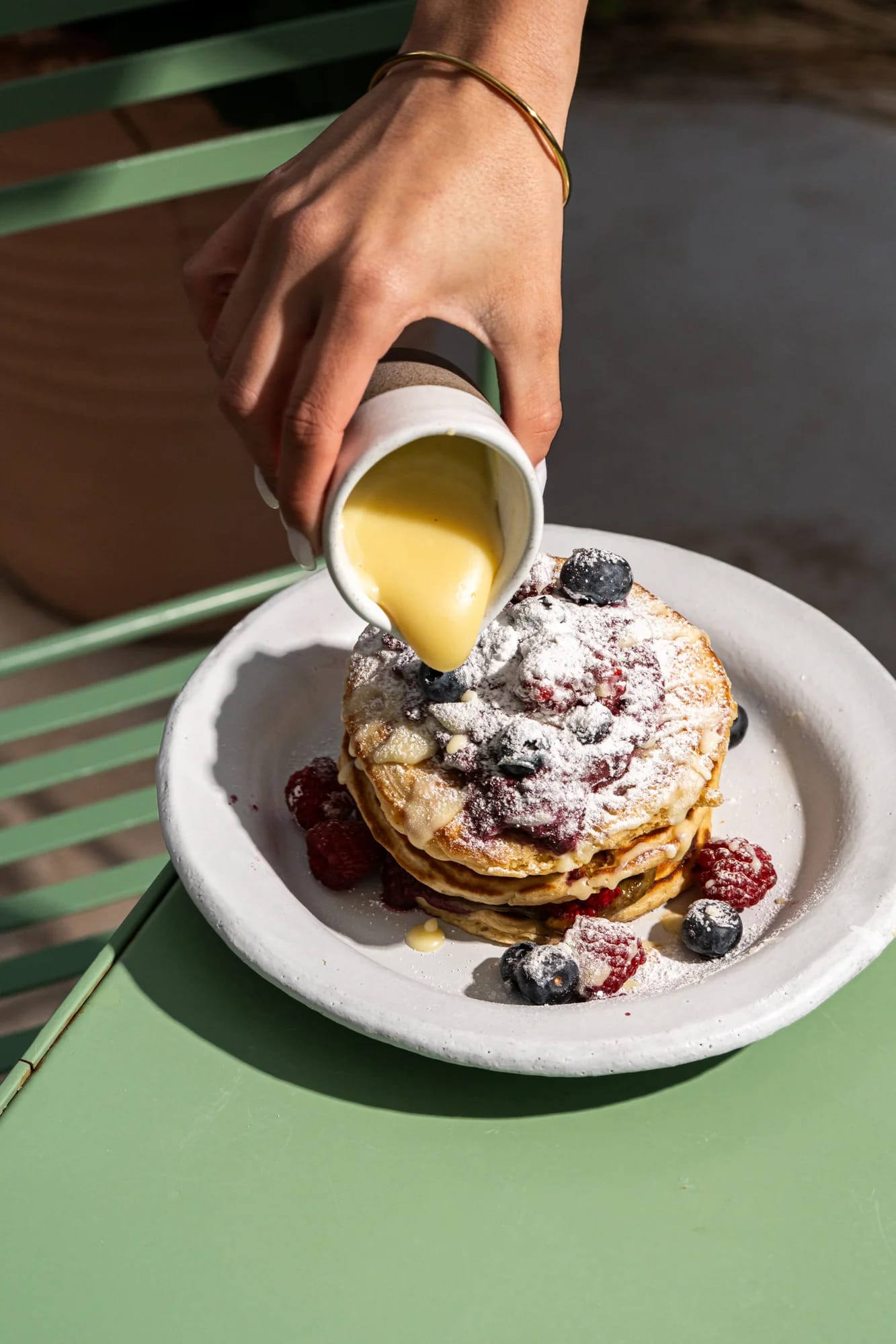pouring custard on pancakes